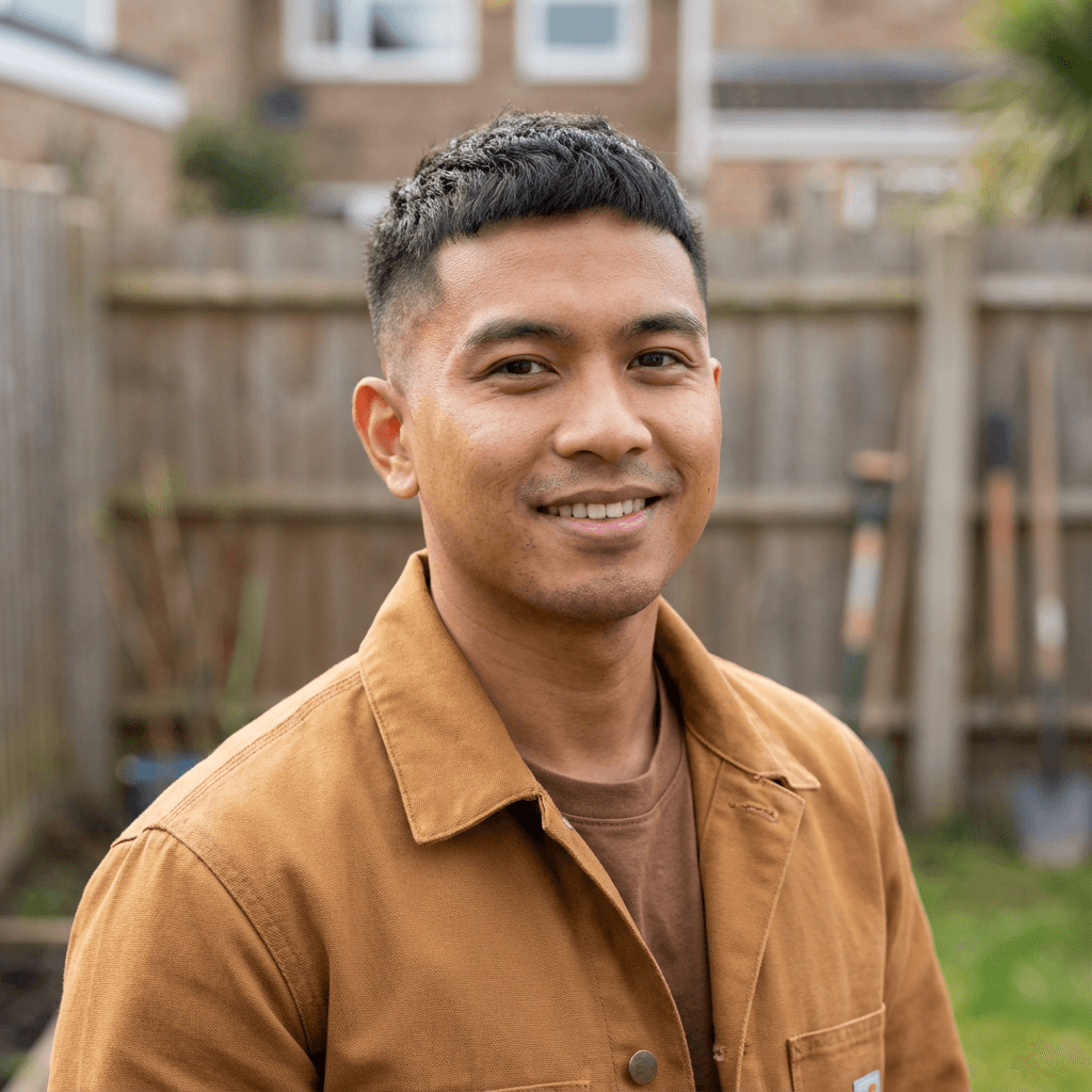 Male homeowner in his 50s, East Asian, calm confident smile, modest dress shirt